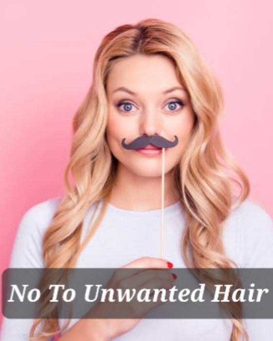 Portrait of funky foolish  big eyed girl holding black carton mustache on stick in hand looking at camera isolated on pink background